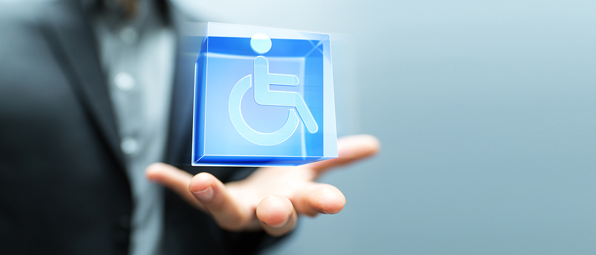 Close-up of a hand open upwards with a cube animated over it, showing the wheelchair user symbol.